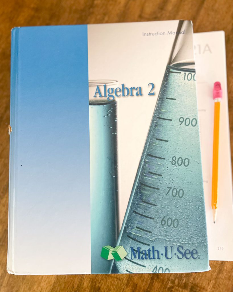A homeschool math textbook with pages and a pencil
