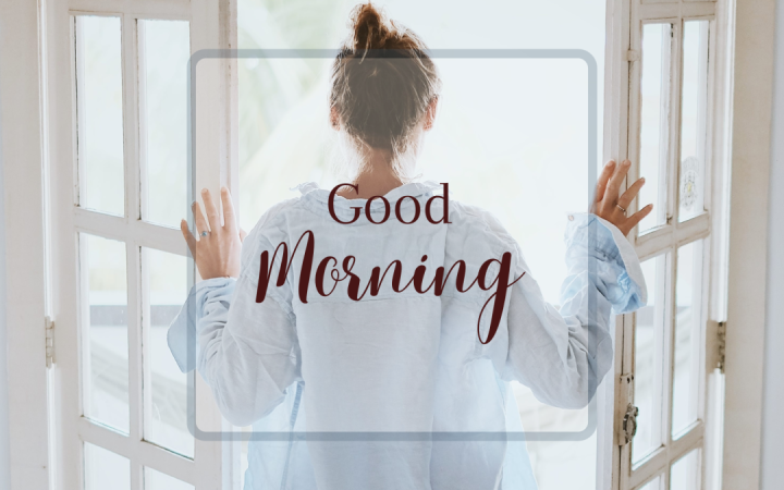 Woman looking out doors with Good Morning written