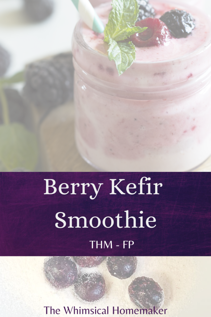 A smoothie in a jar with berries next to it.